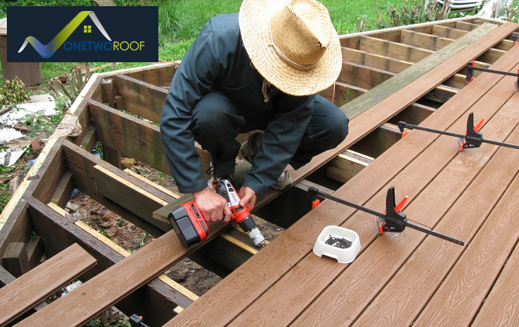 Installation of plywood or wood planks for roof decking construction.