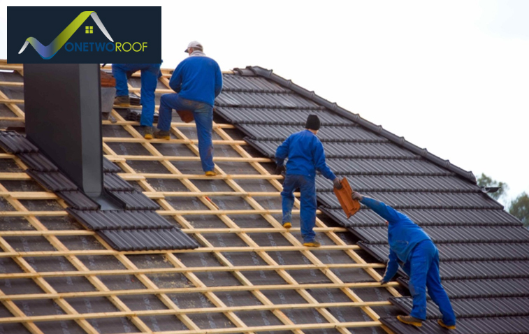 Worker installing roof trusses during construction.